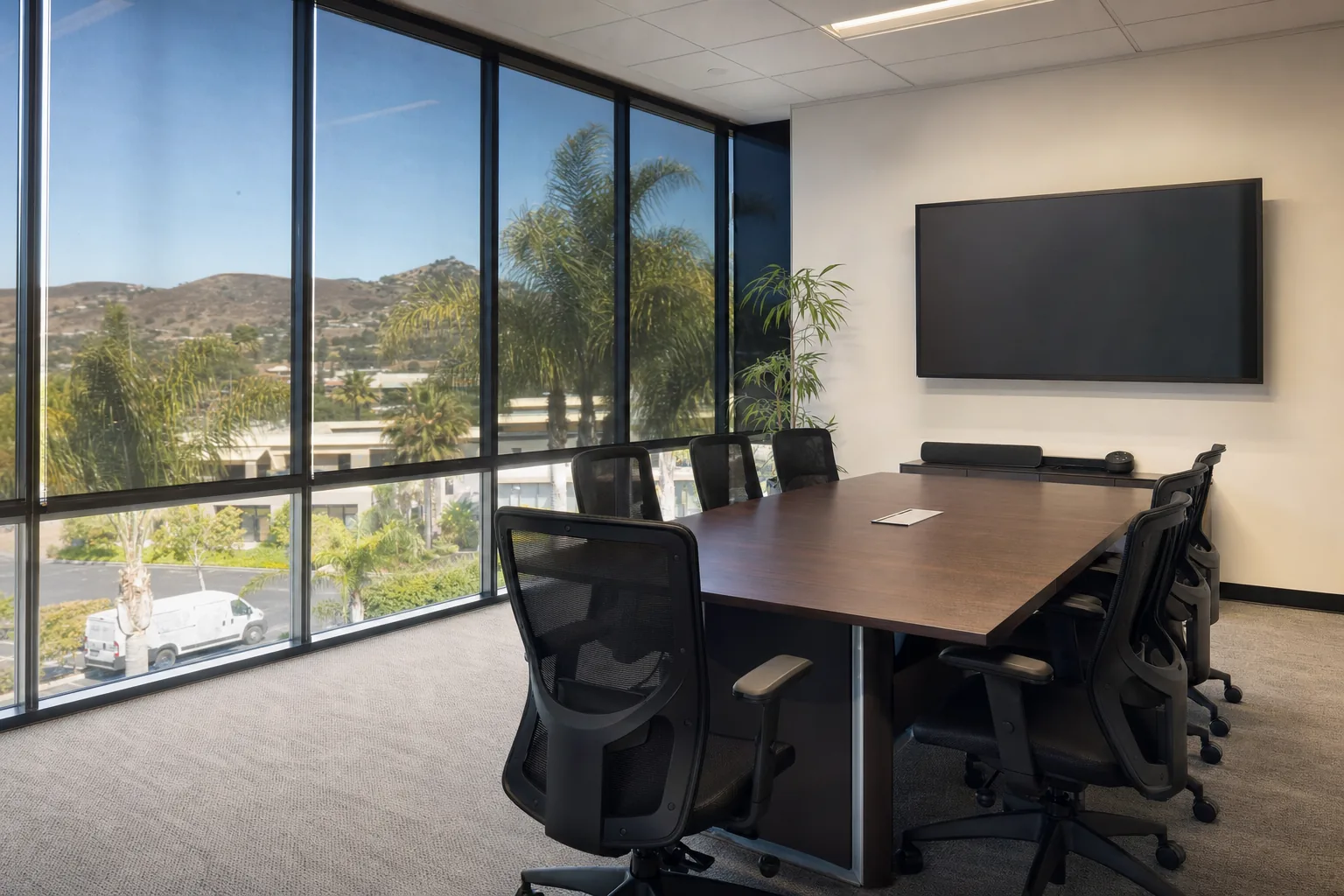 A meeting room with solar film on its window wall, the screen readable with no glare