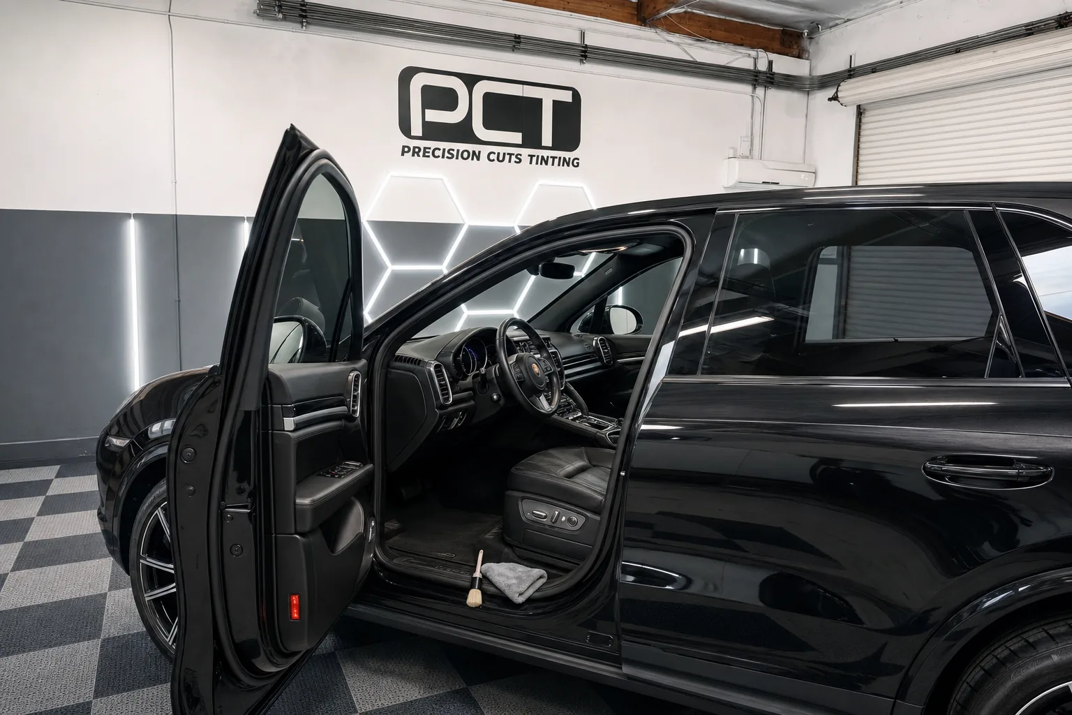 A Porsche Cayenne’s leather interior after detailing, its door open