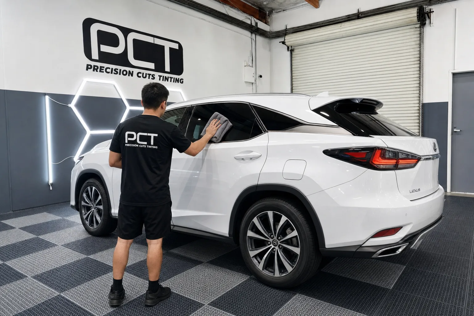 Fresh tint on a white Lexus RX being wiped down and checked