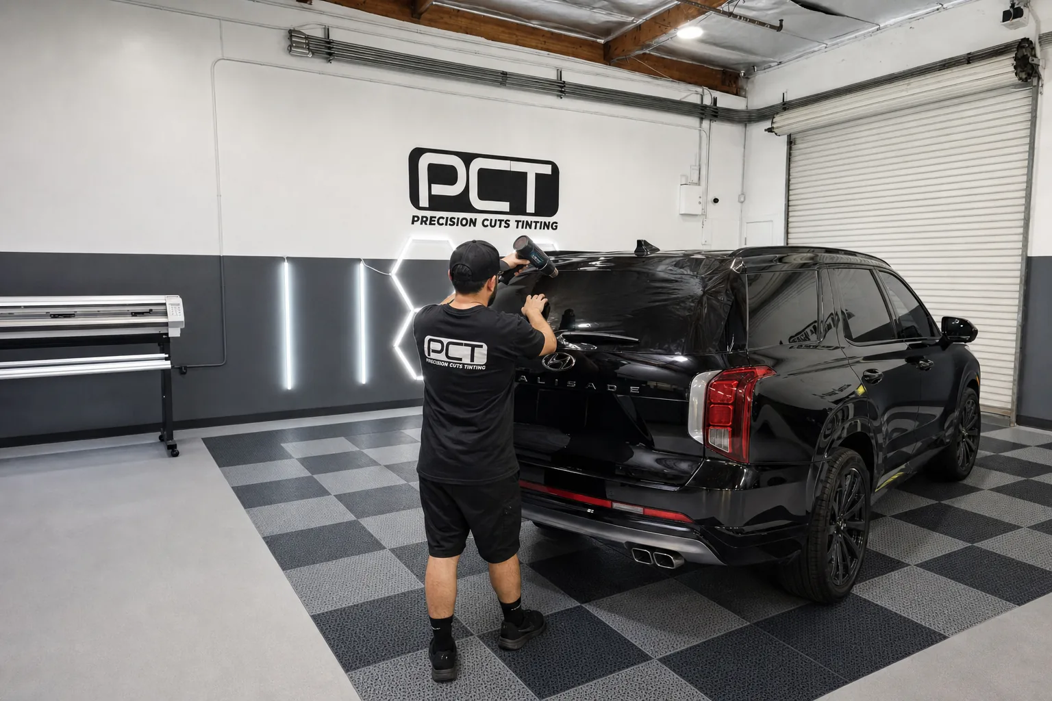Window film being heat-shrunk onto the rear glass of an SUV in our studio