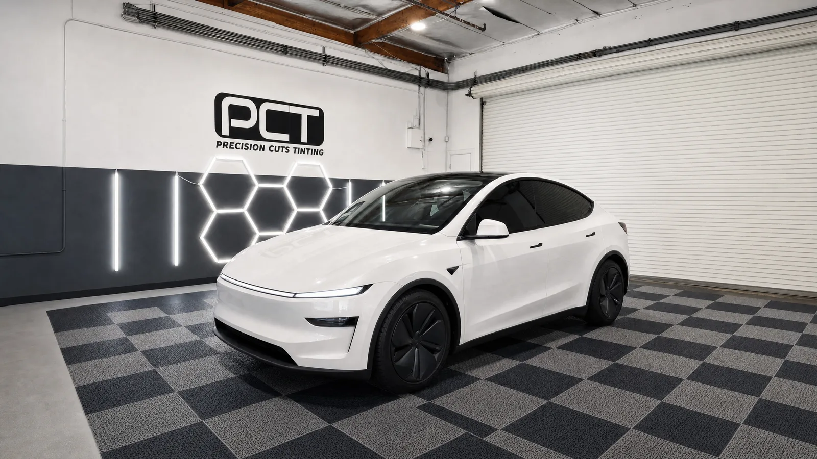 A white Tesla Model Y with fresh ceramic window tint in our studio