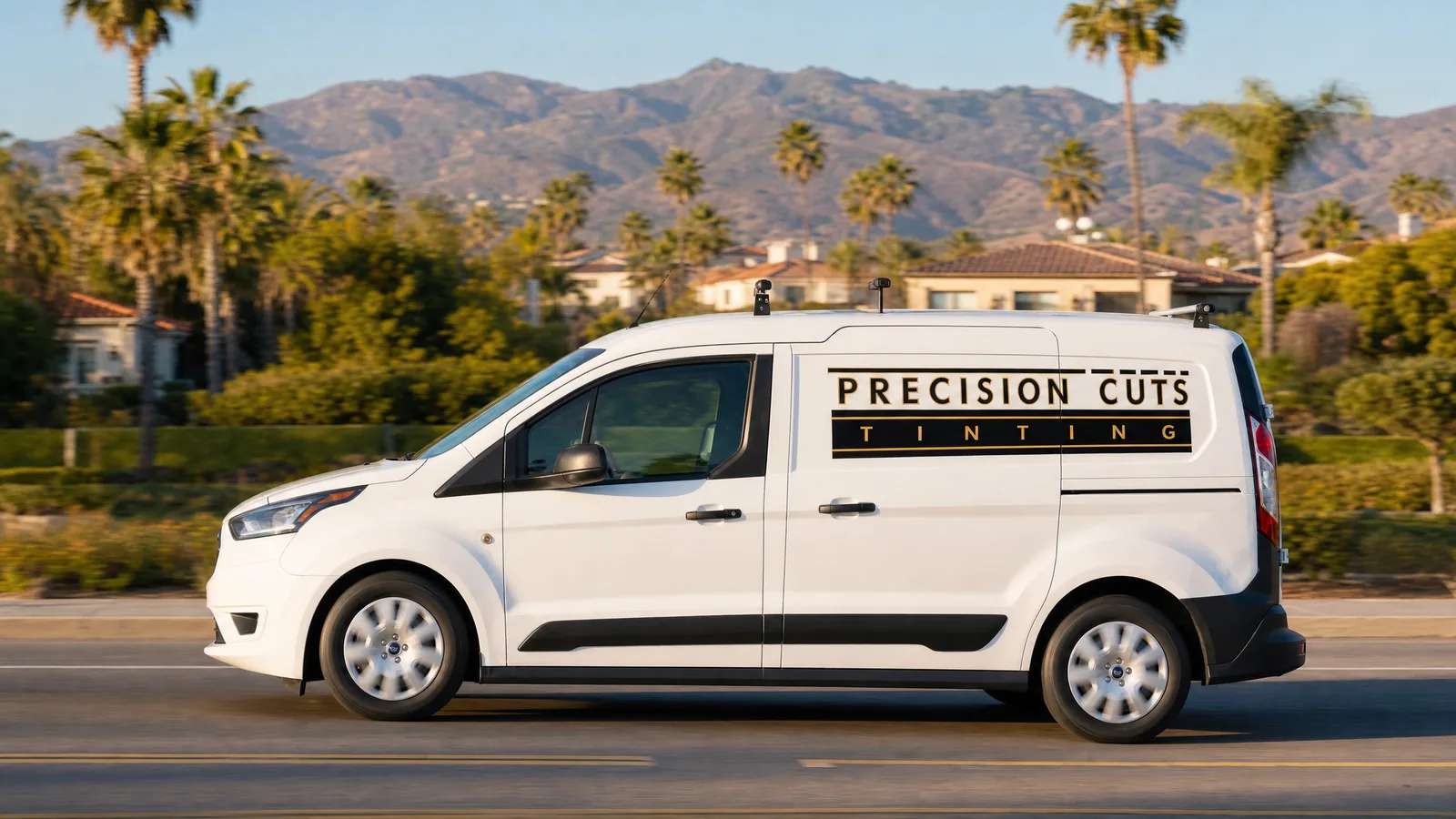 The Precision Cuts Tinting van on its way to a job along a palm-lined road in Yorba Linda