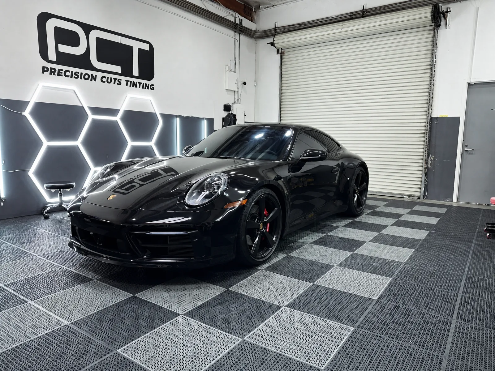 A black Porsche 911 Carrera we tinted, in our studio