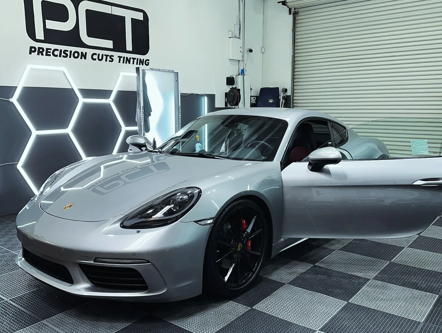 A silver Porsche 718 Cayman we tinted