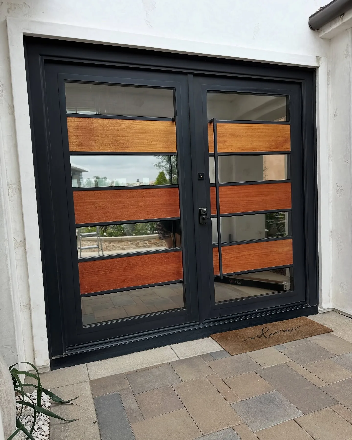 Front-door glass on a modern Spanish-style home, filmed by us