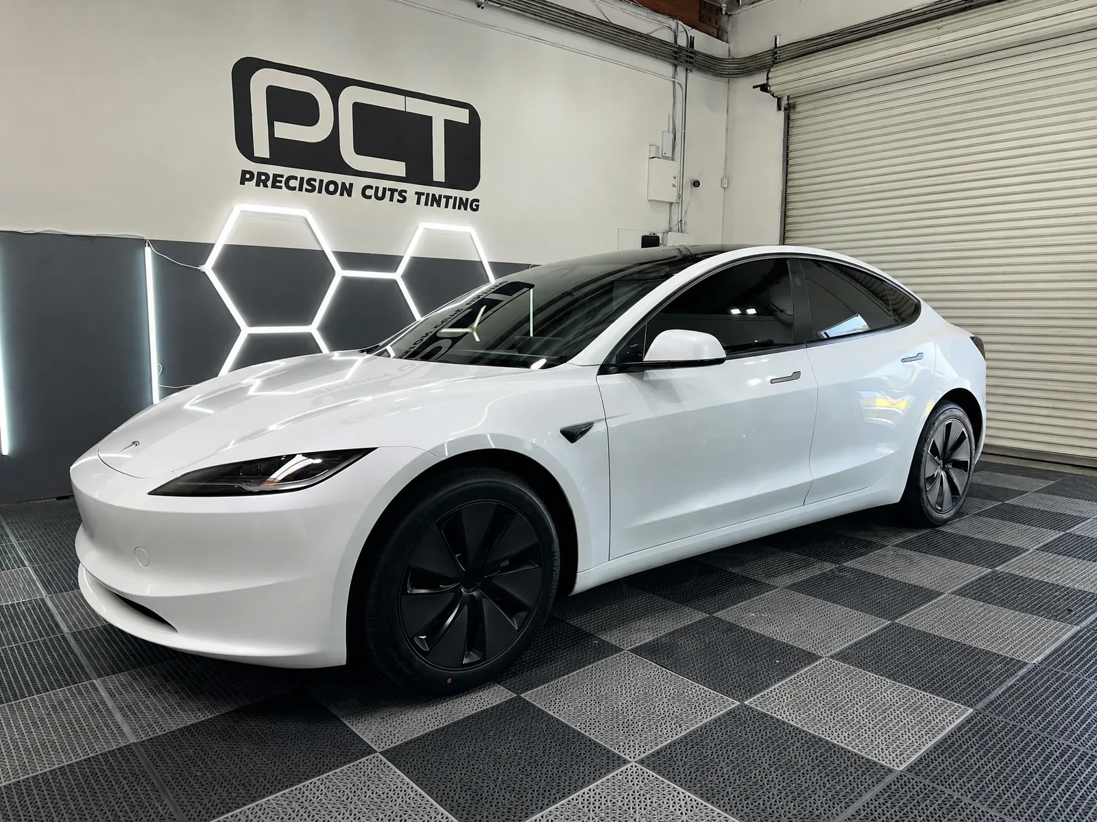 A white Tesla Model 3 we tinted, in our studio