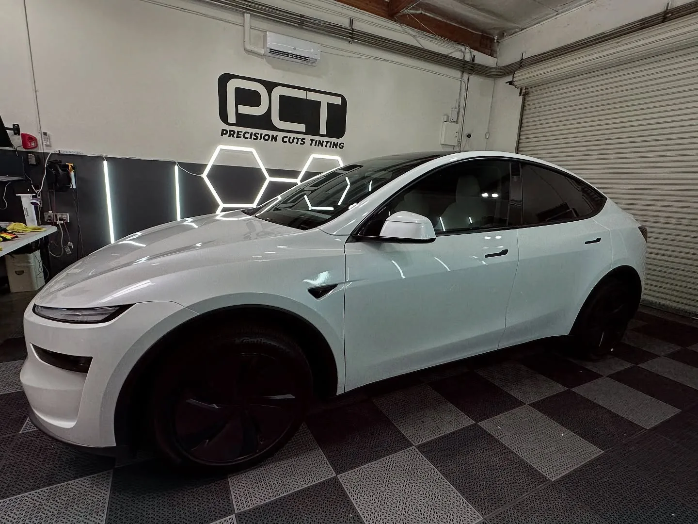 A white Tesla Model Y we tinted