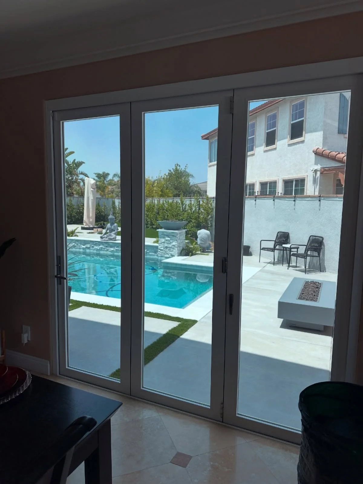 Folding glass doors onto a pool, fitted with window film
