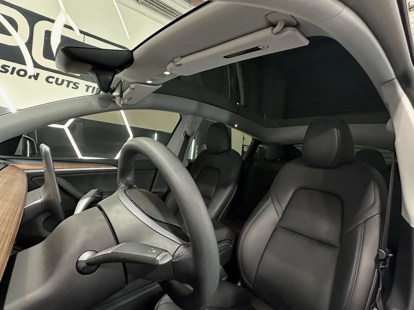 Inside a Tesla we tinted, the PCT sign through the windshield
