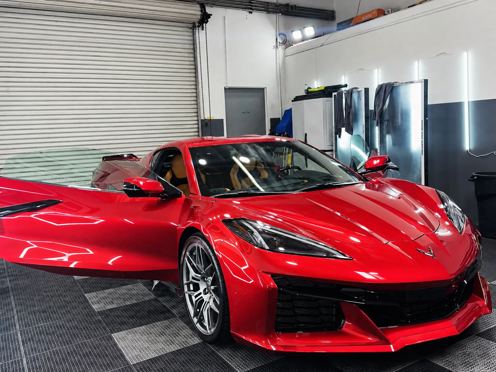 A red Chevrolet Corvette Z06 we tinted, doors open in our studio